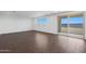 Open living room with wood-look floors and sliding glass door with natural light at 4106 W Eli Dr, San Tan Valley, AZ 85144