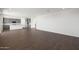 An open-concept living space with wood-look flooring leading to the kitchen at 4106 W Eli Dr, San Tan Valley, AZ 85144