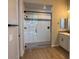 Modern bathroom with a large glass shower, wood-look floors and a white vanity with a gray countertop at 10015 W Verde Ln, Avondale, AZ 85392