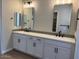 Bathroom featuring double sink vanity with white countertop and contemporary fixtures at 10015 W Verde Ln, Avondale, AZ 85392