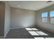 Cozy bedroom with plush carpet and plenty of natural light from two large windows at 10015 W Verde Ln, Avondale, AZ 85392