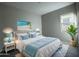 Serene bedroom with light blue accents, natural light, and coastal decor at 10015 W Verde Ln, Avondale, AZ 85392