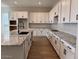Bright kitchen features white cabinets, granite counters, and modern black hardware at 10015 W Verde Ln, Avondale, AZ 85392