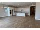 Spacious open concept kitchen and living area with hardwood floors and stainless appliances at 10015 W Verde Ln, Avondale, AZ 85392