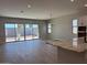 Open-concept living area with large sliding glass doors and tile flooring at 10015 W Verde Ln, Avondale, AZ 85392
