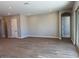 Open living area featuring wood-look tile flooring and neutral walls at 10015 W Verde Ln, Avondale, AZ 85392