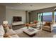 Spacious living room with cozy seating, neutral decor, and sliding glass doors at 10015 W Verde Ln, Avondale, AZ 85392