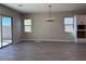 Bright living room with a modern chandelier and sliding glass doors overlooking the backyard at 10015 W Verde Ln, Avondale, AZ 85392