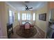 Breakfast nook with glass-top table and four chairs, tile floors, and bay window at 17226 W Calistoga Dr, Surprise, AZ 85387