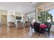 Open living room with dining area and a cozy sitting area by the stone fireplace, perfect for entertaining and relaxing at 10512 E Cortez Dr, Scottsdale, AZ 85259