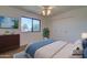 Cozy bedroom with double closet and large window, featuring a dresser and comfy bed at 2104 N Olive Ave, Mesa, AZ 85203