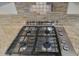 Modern gas cooktop with granite countertops and tile backsplash at 2417 N Higley Rd, Mesa, AZ 85215