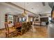 Elegant dining room with a wooden table, chandelier, and open layout to the living area at 10911 E Taos Dr, Scottsdale, AZ 85262