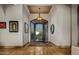 Grand foyer featuring an ornate iron door, decorative lighting, and travertine flooring at 10911 E Taos Dr, Scottsdale, AZ 85262