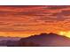 Scenic desert sunset view overlooking silhouetted mountains and an orange sky at 10911 E Taos Dr, Scottsdale, AZ 85262