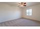 Spacious bedroom with ceiling fan and carpet at 19661 N Echo Rim Dr, Surprise, AZ 85387