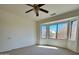 Bright bedroom with large window and ceiling fan at 19661 N Echo Rim Dr, Surprise, AZ 85387