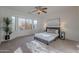 Relaxing bedroom with gray bed, large window, and neutral decor at 19661 N Echo Rim Dr, Surprise, AZ 85387