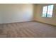 Simple bedroom with carpeted floors and a window at 19661 N Echo Rim Dr, Surprise, AZ 85387