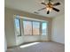 Spacious bedroom featuring a bay window and ceiling fan at 19661 N Echo Rim Dr, Surprise, AZ 85387