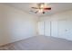 Bright bedroom with ceiling fan and double doors at 19661 N Echo Rim Dr, Surprise, AZ 85387