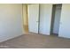 Well-lit bedroom with access to closet and hallway at 19661 N Echo Rim Dr, Surprise, AZ 85387