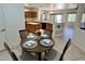 Bright eat-in kitchen features wood cabinetry, granite counters, island, black appliances, and breakfast bar with decorative shelving at 19661 N Echo Rim Dr, Surprise, AZ 85387