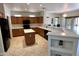 Bright kitchen features wood cabinetry, island, granite counters, black appliances, and breakfast bar with decorative shelving at 19661 N Echo Rim Dr, Surprise, AZ 85387
