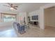 Cozy living room features grey sofa, coffee table, TV console, and large window at 19661 N Echo Rim Dr, Surprise, AZ 85387