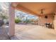 Covered patio with ceiling fan, seating, and desert landscaping at 19661 N Echo Rim Dr, Surprise, AZ 85387