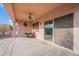 Covered patio with ceiling fan and sliding glass door at 19661 N Echo Rim Dr, Surprise, AZ 85387