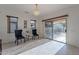 Sunroom with two chairs, chandelier, and sliding glass doors leading to backyard at 19661 N Echo Rim Dr, Surprise, AZ 85387