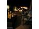 Evening view of backyard patio with seating and water feature at 20620 N Gardenia Rd, Maricopa, AZ 85138