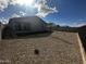 Backyard view showing a home's exterior and a gravel area at 4244 E Bradford Ave, San Tan Valley, AZ 85140