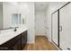 Bathroom featuring double sink vanity, a shower, and wood look floor at 4244 E Bradford Ave, San Tan Valley, AZ 85140