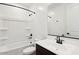 Bright white bathroom features a shower-tub combination and vanity at 4244 E Bradford Ave, San Tan Valley, AZ 85140