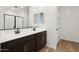 Bathroom featuring double sink vanity with black hardware and dark wood cabinets at 4244 E Bradford Ave, San Tan Valley, AZ 85140