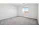 An airy bedroom is carpeted and bright with a large window at 4244 E Bradford Ave, San Tan Valley, AZ 85140