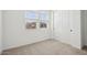 A carpeted bedroom with two windows and a double door closet at 4244 E Bradford Ave, San Tan Valley, AZ 85140