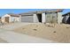 Single-story home showcasing gray stucco and drought-resistant landscaping with a two car garage and covered entry at 4244 E Bradford Ave, San Tan Valley, AZ 85140