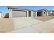 Single-story home featuring gray stucco and drought-resistant landscaping with a two car garage and covered entry at 4244 E Bradford Ave, San Tan Valley, AZ 85140