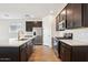 Modern kitchen showcasing a white island, stainless steel appliances, and dark cabinets at 4244 E Bradford Ave, San Tan Valley, AZ 85140