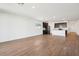 Bright open-concept living area with wood-look tile and kitchen featuring a white island at 4244 E Bradford Ave, San Tan Valley, AZ 85140