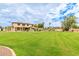 Sprawling backyard with lush lawn, patio, mature trees, and plenty of space for recreation at 5312 N Sierra Hermosa Ct, Litchfield Park, AZ 85340