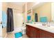 Bathroom with brown vanity, bathtub-shower, tile flooring, and neutral paint at 5312 N Sierra Hermosa Ct, Litchfield Park, AZ 85340