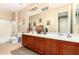 Bathroom with double vanity and shower-tub combination at 5312 N Sierra Hermosa Ct, Litchfield Park, AZ 85340