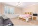 Bedroom with wainscoting, a wood-framed bed, carpet, and shuttered windows to let in natural light at 5312 N Sierra Hermosa Ct, Litchfield Park, AZ 85340