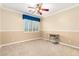 Bedroom with a ceiling fan, window with shutters, and neutral-colored walls at 5312 N Sierra Hermosa Ct, Litchfield Park, AZ 85340