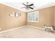 Neutral-colored bedroom featuring a ceiling fan and window with white shutters at 5312 N Sierra Hermosa Ct, Litchfield Park, AZ 85340