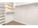 Walk-in closet with open shelving, rods, and neutral paint; ready to be filled with your belongings at 5312 N Sierra Hermosa Ct, Litchfield Park, AZ 85340